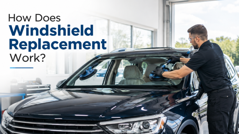 Technician installing new windshield in auto repair shop